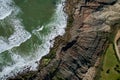 Beautiful drone shot of waves on rocky shore.