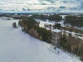 Beautiful drone winter landscape of Poland - snowy fields, lake, river and forest aerial view Royalty Free Stock Photo