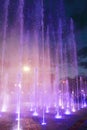 Beautiful dry fountain with bright illuminated splashes