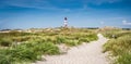 Beautiful dune landscape with traditional lighthouse at North Sea Royalty Free Stock Photo