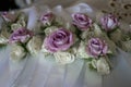 Beautiful dusky mauve roses as wedding accessories for bride, guests and and decor for tables
