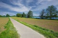 Beautiful dutch rural landscape, maas riverside cycling path, agriculture fields, trees, blue spring sky - Limburg, Netherlands
