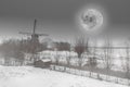 Beautiful Dutch winter windmill landscape with full moon black and white Royalty Free Stock Photo