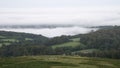 Beautiful early morning cloud inversion over Dartmoor National Park in England with thick cloud in valley of forest