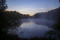 Beautiful early morning foggy lake distant golden hour sky Royalty Free Stock Photo