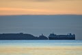 Beautiful early morning view of sea truck ferry ship in Irish Sea near Baily lighthouse seen from Blackrock Beach, Dublin, Ireland Royalty Free Stock Photo