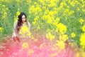 At beautiful early spring, a young woman stand in the middle of yellow flowers filed which is the biggest in Shanghai Royalty Free Stock Photo