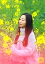 At beautiful early spring, a young woman stand in the middle of yellow flowers filed which is the biggest in Shanghai Royalty Free Stock Photo