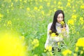 At beautiful early spring, a young woman stand in the middle of yellow flowers filed which is the biggest in Shanghai Royalty Free Stock Photo