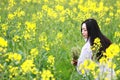 At beautiful early spring, a young woman stand in the middle of yellow flowers filed which is the biggest in Shanghai Royalty Free Stock Photo