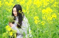 At beautiful early spring, a young woman stand in the middle of yellow flowers filed which is the biggest in Shanghai Royalty Free Stock Photo