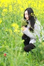 At beautiful early spring, a young woman stand in the middle of yellow flowers filed which is the biggest in Shanghai Royalty Free Stock Photo