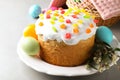 Beautiful Easter cake and painted eggs on light grey table Royalty Free Stock Photo