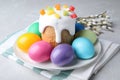 Beautiful Easter cake and painted eggs on light grey marble table Royalty Free Stock Photo
