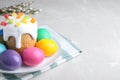 Beautiful Easter cake and painted eggs on light grey marble table. Space for text Royalty Free Stock Photo