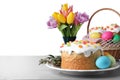 Beautiful Easter cake and painted eggs on light grey table against white background. Space for text Royalty Free Stock Photo