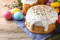 Beautiful Easter cake and painted eggs on wooden table Royalty Free Stock Photo