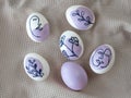 Beautiful Easter eggs on a kitchen towel, purple pattern.