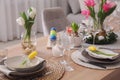 Beautiful Easter table setting with beautiful flowers indoors Royalty Free Stock Photo