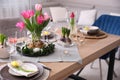 Beautiful Easter table setting with beautiful flowers in living room Royalty Free Stock Photo