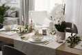 Beautiful Easter table setting with white orchid flowers indoors Royalty Free Stock Photo