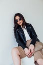 Beautiful fashionable eastern brunette woman in black leather jacket Royalty Free Stock Photo