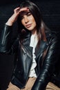 Beautiful fashionable eastern brunette woman in black leather jacket Royalty Free Stock Photo