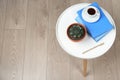 Beautiful Echeveria plant, books and cup of coffee on table at home, above view. Space for text