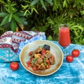 Beautiful eggplant salad with tomato, juice on the table