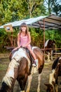 Beautiful eight year old girl on the horse