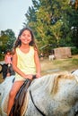 Beautiful eight year old girl on the horse