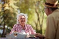 Beautiful elderly couple enjoy outdoor, having breakfast and coffee Royalty Free Stock Photo