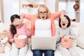 Beautiful elderly grandmother watching horror film on laptop with her grandchildren together.