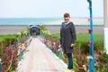 Beautiful elderly woman on the alley with blooming flowers. Royalty Free Stock Photo