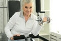 Beautiful elderly woman exercising in the gym Royalty Free Stock Photo