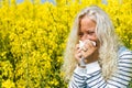 Beautiful elderly Woman has to sneeze