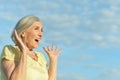 beautiful elderly woman laughing against the sky Royalty Free Stock Photo