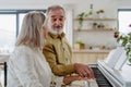 Beautiful eldery couple playing a piano at home Royalty Free Stock Photo