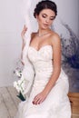 Beautiful elegant bride in wedding dress sitting on swing