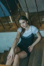 Beautiful elegant brunette girl wearing a black dress is relaxing in a street cafe. Advertising, fashion. Tinted photo Royalty Free Stock Photo