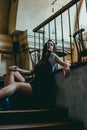 Beautiful elegant brunette girl wearing a black dress is relaxing in a street cafe. Advertising, fashion. Tinted photo Royalty Free Stock Photo