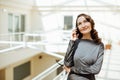 Beautiful elegant business woman with smartphone in her hand is calling Royalty Free Stock Photo