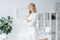 beautiful elegant businesswoman in white clothes in modern light