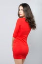 Beautiful elegant fashionable girl in red dress posing in studio