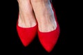 Woman feet with red shoes on black background. Royalty Free Stock Photo
