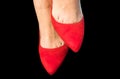 Woman feet with red shoes on black background. Royalty Free Stock Photo