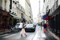 Beautiful elegant girl in Paris on the background of the Eiffel Tower walks around Paris