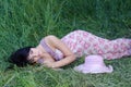 Beautiful elegant girl sleeping in high grass in spring Royalty Free Stock Photo