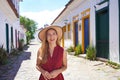 Beautiful elegant girl visiting Brazil. Holidays in the colonial historic town of Paraty UNESCO World Heritage Site. Ads for