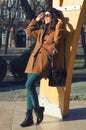 Beautiful elegant lady enjoying sunny spring day in the park